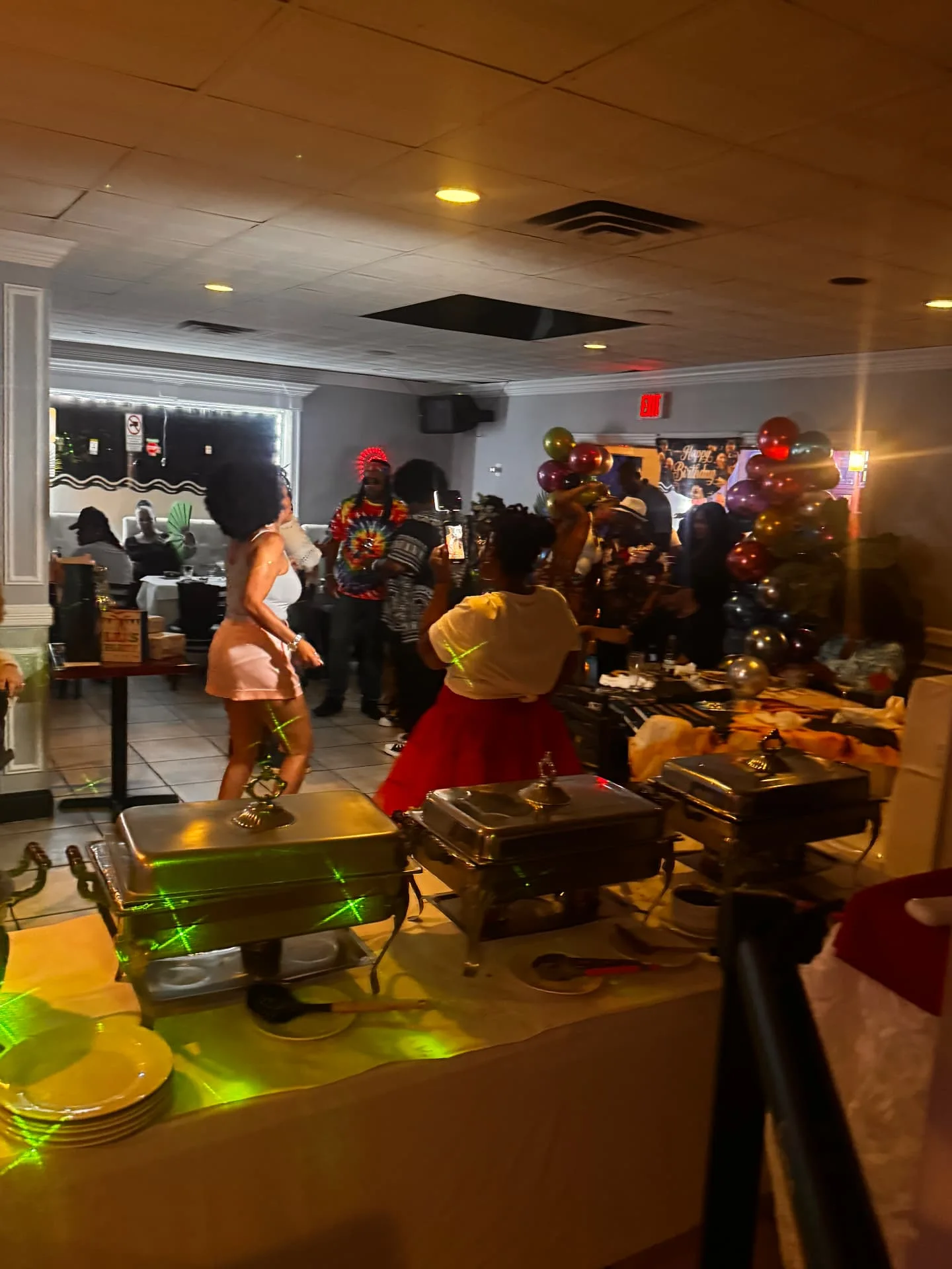 A celebration buffet and guests at Spices Negril